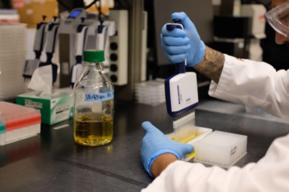 A DNASU scientist using a dropper to fill vials. Photo courtesy of ASU Media Relations
